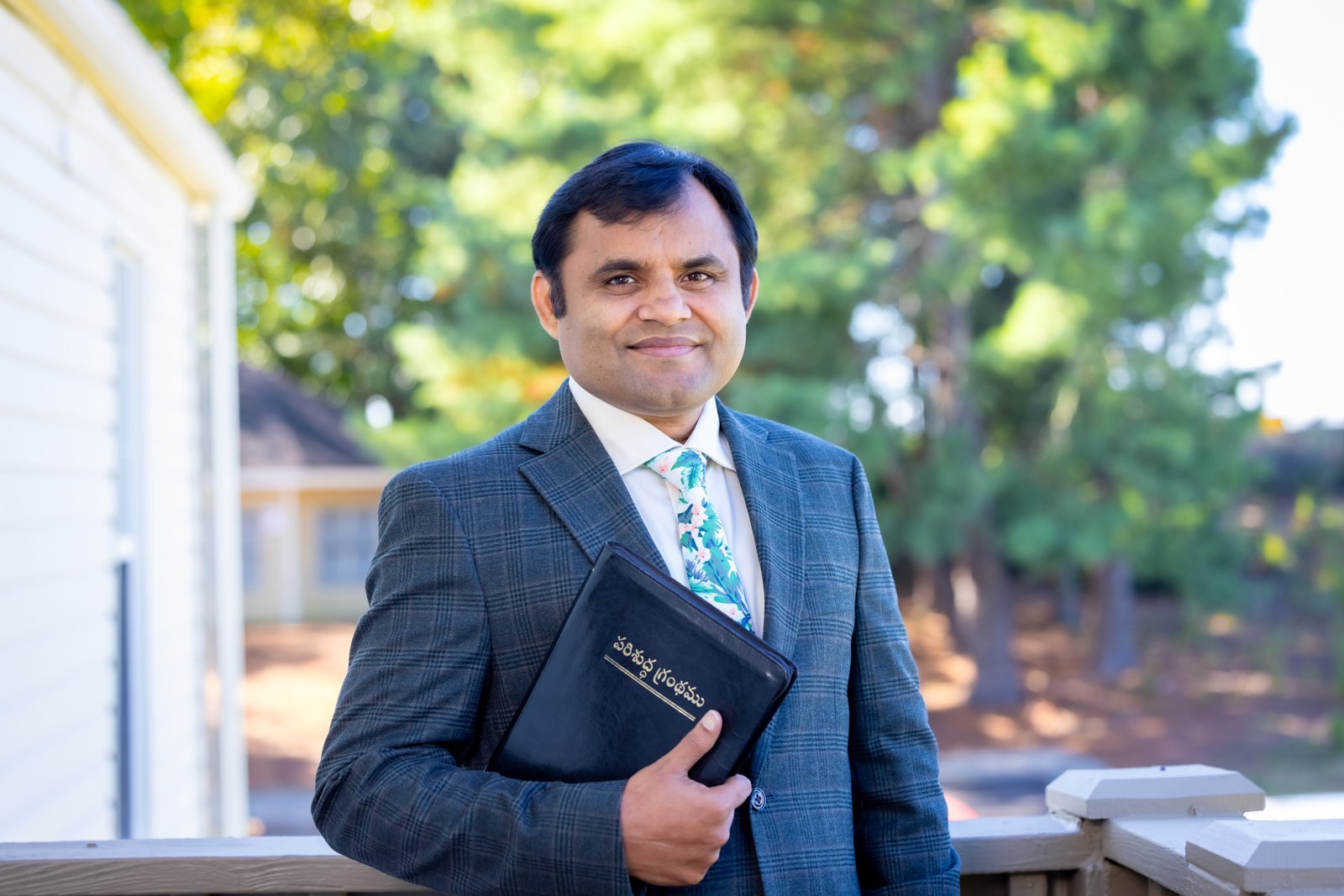 Pastor Jonathan Naik holding the Bible