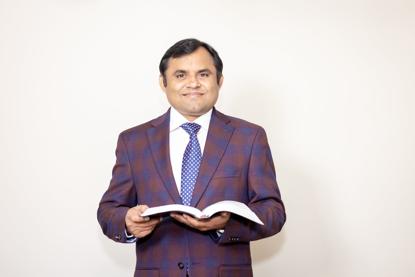 Pastor Jonathan Naik holding the Bible